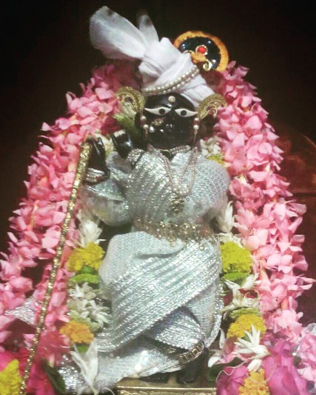 Shri Radharaman Temple, Vrindavan, deity statue, Lord Krishna, temple worship, floral decoration, Hinduism, religious art, spiritual atmosphere, divine representation, Top ten Lord Krishna Temples