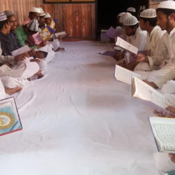 madrasa, education, Islamic studies, group study, traditional dress, religious education, communal learning, young men studying