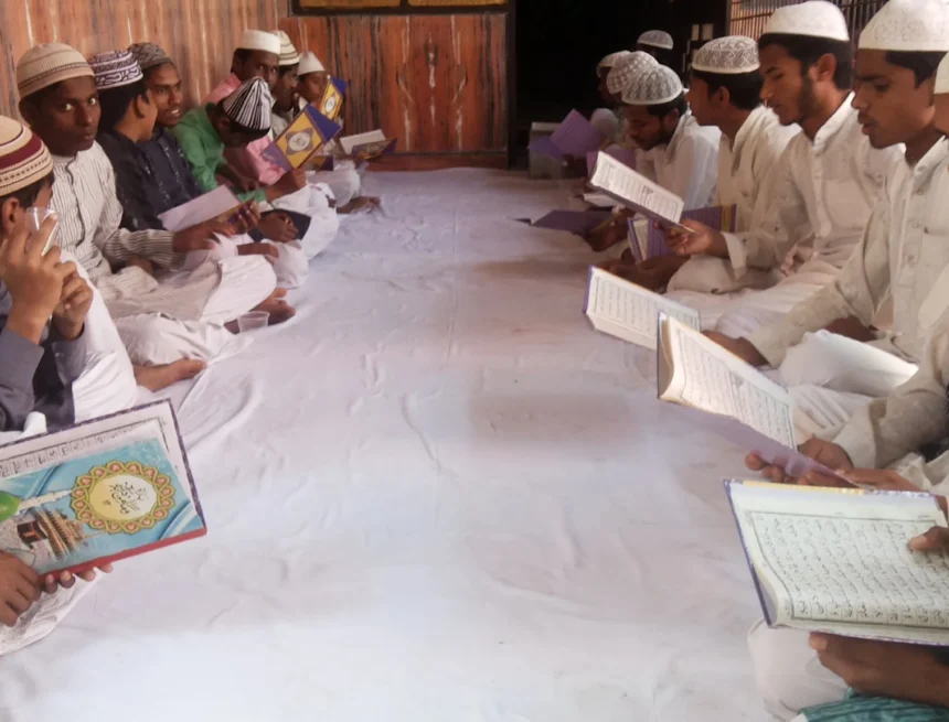 Typical_Madarsa_In_India_WebP madrasa, education, Islamic studies, group study, traditional dress, religious education, communal learning, young men studying