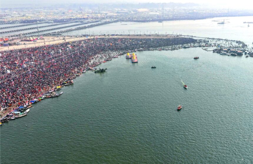 Kumbh Mela, aerial view, river confluence, Prayagraj, massive crowd, spiritual gathering, ceremonial boats, festival, cultural event