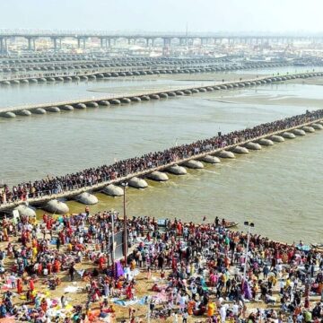 Kumbh Mela, Triveni Sangam, Prayagraj, Hindu festival, religious gathering, pontoon bridges, aerial view, river confluence, mass pilgrimage, cultural heritage, Mahakumbha 2025