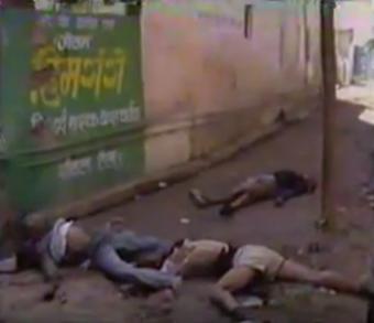 tragedy, violence, aftermath, deserted street, billboard, Hindi advertisement